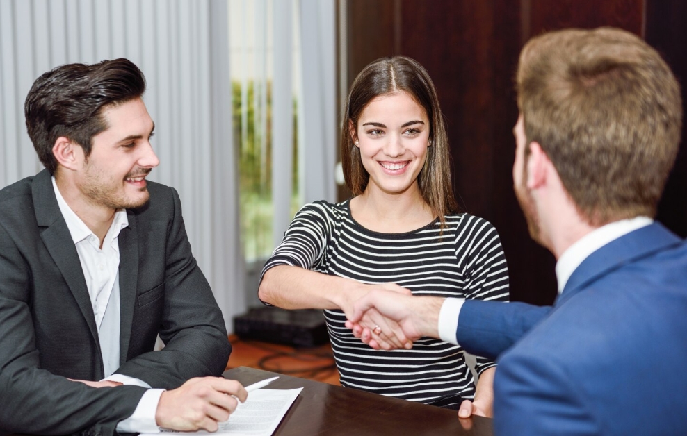 Business professionals shaking hands at meeting