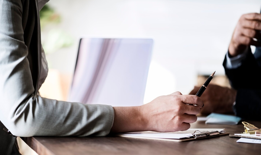 Person taking notes in meeting